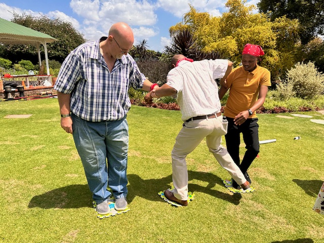 A group engaging in a fun team building activity facilitated by bynage