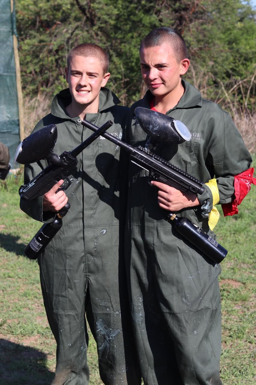 team playing paintball strategy game outdoors