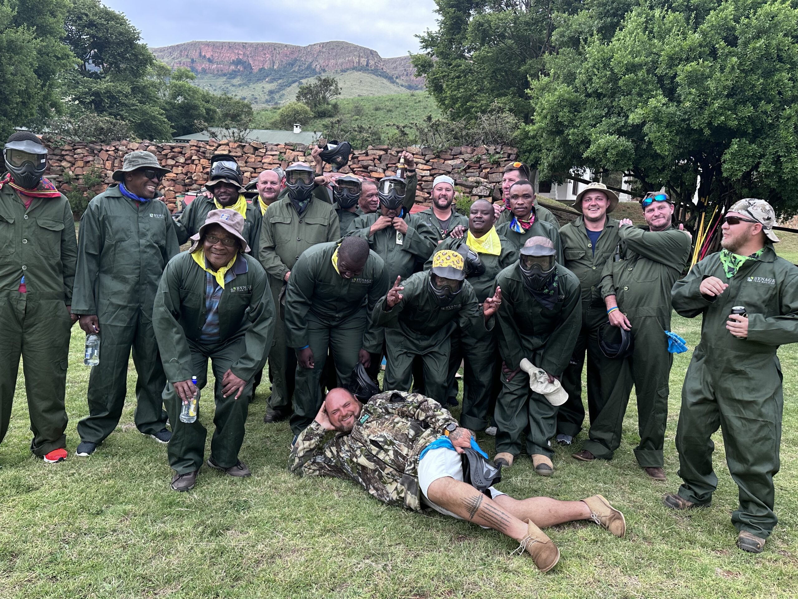 group of players in paintball gear team building