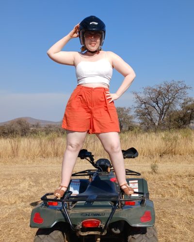 woman standing on quad bike during adventure experience