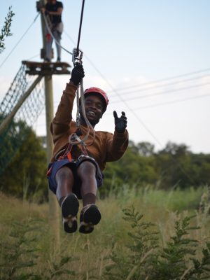 Zipline image Zipline Polokwane zipline Polokwane Zipline Adventure Experience zipline-polokwane.jpg person ziplining over outdoor adventure course Supporting